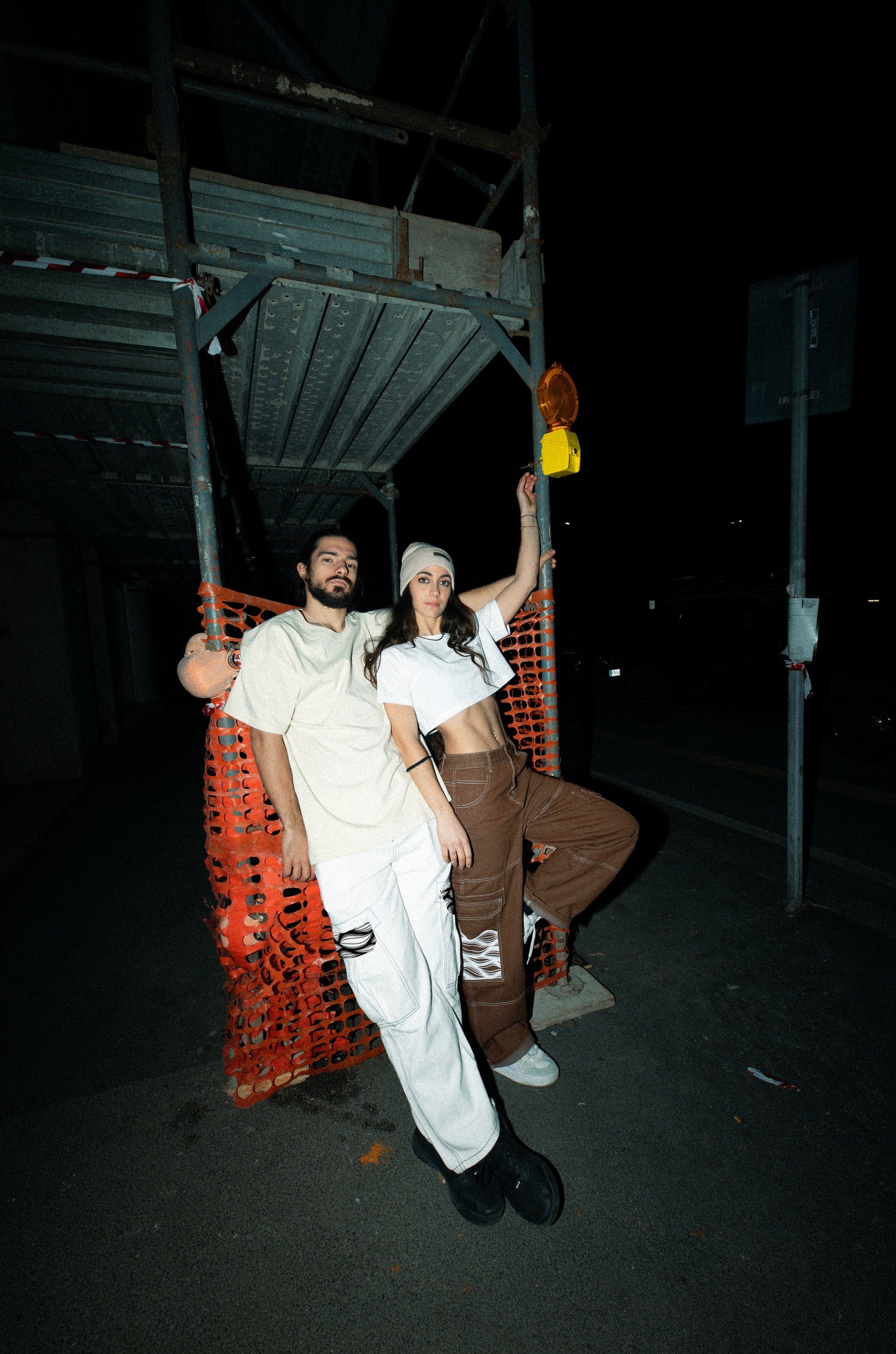 Giorgio Geo Bartolucci wearing Moondi clothing white cargo pants And Monica Del Piano wearing brown cargo pants